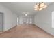 Spacious carpeted living room with French doors, crown molding, and classic lighting at 1538 Lanterns Rest Rd. # 103, Myrtle Beach, SC 29579