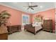 Charming bedroom with antique furniture and coral-colored walls at 1601 Waterway Dr., North Myrtle Beach, SC 29582