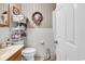 A quaint bathroom, with toilet, sink, and storage at 1817 South Island Rd., Georgetown, SC 29440