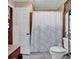 Full bathroom with a toilet and a tub/shower with a patterned shower curtain at 1817 South Island Rd., Georgetown, SC 29440