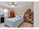 Comfortable bedroom with soft blue bedding, wooden dresser, bookshelf, and natural light, creating a cozy atmosphere at 1817 South Island Rd., Georgetown, SC 29440