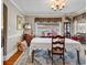 Bright dining room featuring a chandelier, natural light, vintage furniture, and hardwood floors at 1817 South Island Rd., Georgetown, SC 29440