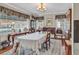 Traditional dining room with chandelier, table with lace cloth, and windows offering bright, inviting space at 1817 South Island Rd., Georgetown, SC 29440