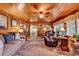 Inviting living room with wood paneled walls and ceiling, comfortable furniture, and a smooth transition to dining area at 1817 South Island Rd., Georgetown, SC 29440