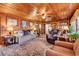 Cozy living room featuring wood paneled walls, ceiling fan, and comfortable seating with natural light at 1817 South Island Rd., Georgetown, SC 29440