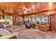 Welcoming living room with wood paneled walls, ceiling fan, and an open layout that flows into dining room at 1817 South Island Rd., Georgetown, SC 29440