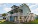 Two-story teal home with white trim, elevated foundation, and stairs at 719 N Waccamaw Dr., Murrells Inlet, SC 29576