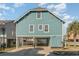 Front view of teal house, elevated, with stairs and parking underneath at 719 N Waccamaw Dr., Murrells Inlet, SC 29576