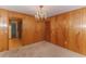 Dining room with wood paneling, chandelier, and access to kitchen at 1901 Harris Short Cut Rd., Conway, SC 29526