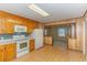 Kitchen with wood cabinets, laminate floor, and view into adjacent room at 1901 Harris Short Cut Rd., Conway, SC 29526