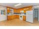 Bright kitchen features wood cabinets, laminate flooring and built-in microwave at 1901 Harris Short Cut Rd., Conway, SC 29526