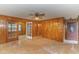 Living room with wood paneled walls, ceiling fan, and French doors at 1901 Harris Short Cut Rd., Conway, SC 29526