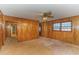 Living area featuring wood paneling, large windows, and laminate flooring at 1901 Harris Short Cut Rd., Conway, SC 29526