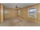 Spacious living room with large windows and wood-paneled walls at 1901 Harris Short Cut Rd., Conway, SC 29526