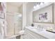 Contemporary bathroom featuring a walk-in shower with glass door and bright vanity lighting at 2110 Green Heron Dr., Murrells Inlet, SC 29576