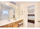 Bathroom with wood cabinets and a view into a bedroom, offering convenience and style at 2110 Green Heron Dr., Murrells Inlet, SC 29576