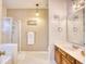 Neutral bathroom featuring a glass-enclosed shower, vanity with wood cabinets, and ample lighting at 2110 Green Heron Dr., Murrells Inlet, SC 29576