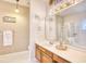 Well-lit bathroom featuring a vanity, large mirror, and a shower with a glass door for a modern touch at 2110 Green Heron Dr., Murrells Inlet, SC 29576