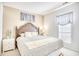 Bright bedroom with a decorative wooden headboard, soft bedding, and natural light from the window at 2110 Green Heron Dr., Murrells Inlet, SC 29576