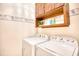 Functional laundry room featuring a washer, dryer, and upper cabinets for storage at 2110 Green Heron Dr., Murrells Inlet, SC 29576