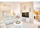 Bright living room with white sofas, neutral carpet, modern decor, and a view into the kitchen at 2110 Green Heron Dr., Murrells Inlet, SC 29576