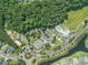 Aerial view of community featuring tennis courts, pool, playground, river, and meticulously landscaped areas in a great location at 212 Minnow Ln., Murrells Inlet, SC 29576