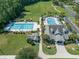 Aerial view of a community pool, clubhouse and surrounding landscaping, offering recreational amenities and a relaxing atmosphere at 212 Minnow Ln., Murrells Inlet, SC 29576