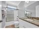 Well-lit bathroom with a granite countertop, white cabinets, and a shower-tub combination at 212 Minnow Ln., Murrells Inlet, SC 29576