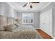 Bright bedroom featuring a ceiling fan, hardwood floors, a large bed, and a bright window at 212 Minnow Ln., Murrells Inlet, SC 29576