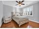 Comfortable bedroom with a ceiling fan, hardwood floors, a cozy chair, and a bright window at 212 Minnow Ln., Murrells Inlet, SC 29576