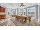 Bright dining area featuring a large wooden table set beneath a ceiling fan and next to multiple shuttered windows at 212 Minnow Ln., Murrells Inlet, SC 29576