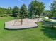 Community playground with slide, climbing structures, benches, and picnic tables in a well-maintained grassy area at 212 Minnow Ln., Murrells Inlet, SC 29576