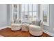 Inviting sitting area with two chairs, an ottoman, and a view of the outside through shuttered windows at 212 Minnow Ln., Murrells Inlet, SC 29576