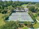 Aerial view of well-maintained tennis courts with lush landscaping and mature trees in a vibrant community setting at 212 Minnow Ln., Murrells Inlet, SC 29576