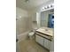 Bright bathroom featuring a tub-shower combo, toilet, vanity, and a mirror with decorative lights at 2265 Huntington Dr. # A, Surfside Beach, SC 29575