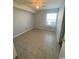 Simple bedroom with neutral walls, tile floors, and natural light from a window at 2265 Huntington Dr. # A, Surfside Beach, SC 29575