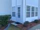 Exterior view of the building with a white door, window, and landscaping at 2265 Huntington Dr. # A, Surfside Beach, SC 29575