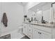 Elegant bathroom with granite countertop, white cabinets, and a large mirror at 2475 Blue Crane Circle # 104, Myrtle Beach, SC 29577