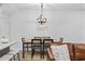 Modern dining area with a rustic wood table and chandelier at 2475 Blue Crane Circle # 104, Myrtle Beach, SC 29577