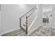 Modern staircase with wood railing leading to the upper level at 2475 Blue Crane Circle # 104, Myrtle Beach, SC 29577