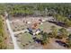 High angle aerial view of house, highlighting the large fenced lot, outbuildings, and surrounding trees at 2531 Smiley Ln., Conway, SC 29526