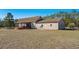 Exterior view of the home with a large backyard, screened porch, and brick exterior at 2531 Smiley Ln., Conway, SC 29526