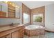 Bathroom featuring a corner tub with jets, a vanity with a mirror, and a light fixture at 2531 Smiley Ln., Conway, SC 29526