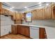 Kitchen featuring light countertops, wooden cabinets, white dishwasher, and natural light from a window at 2531 Smiley Ln., Conway, SC 29526