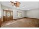 Cozy living room featuring carpet, a decorative front door, and a large window at 2531 Smiley Ln., Conway, SC 29526