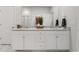 Elegant bathroom featuring a double vanity, granite countertop, and white cabinets, exuding a spa-like ambiance at 2539 Blue Crane Circle # 101, Myrtle Beach, SC 29577