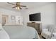 Spacious bedroom featuring a TV, ceiling fan, and a striped chair, creating a cozy and inviting retreat at 2539 Blue Crane Circle # 101, Myrtle Beach, SC 29577