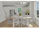 Bright dining area with a wooden table, white chairs, and white cabinets, creating a fresh and inviting space at 2539 Blue Crane Circle # 101, Myrtle Beach, SC 29577