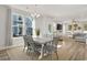 Bright dining area with a modern chandelier and plenty of natural light and open to the living room at 2539 Blue Crane Circle # 101, Myrtle Beach, SC 29577