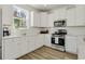 Bright kitchen featuring white cabinets, stainless steel appliances, subway tile backsplash and wood floor at 2539 Blue Crane Circle # 101, Myrtle Beach, SC 29577